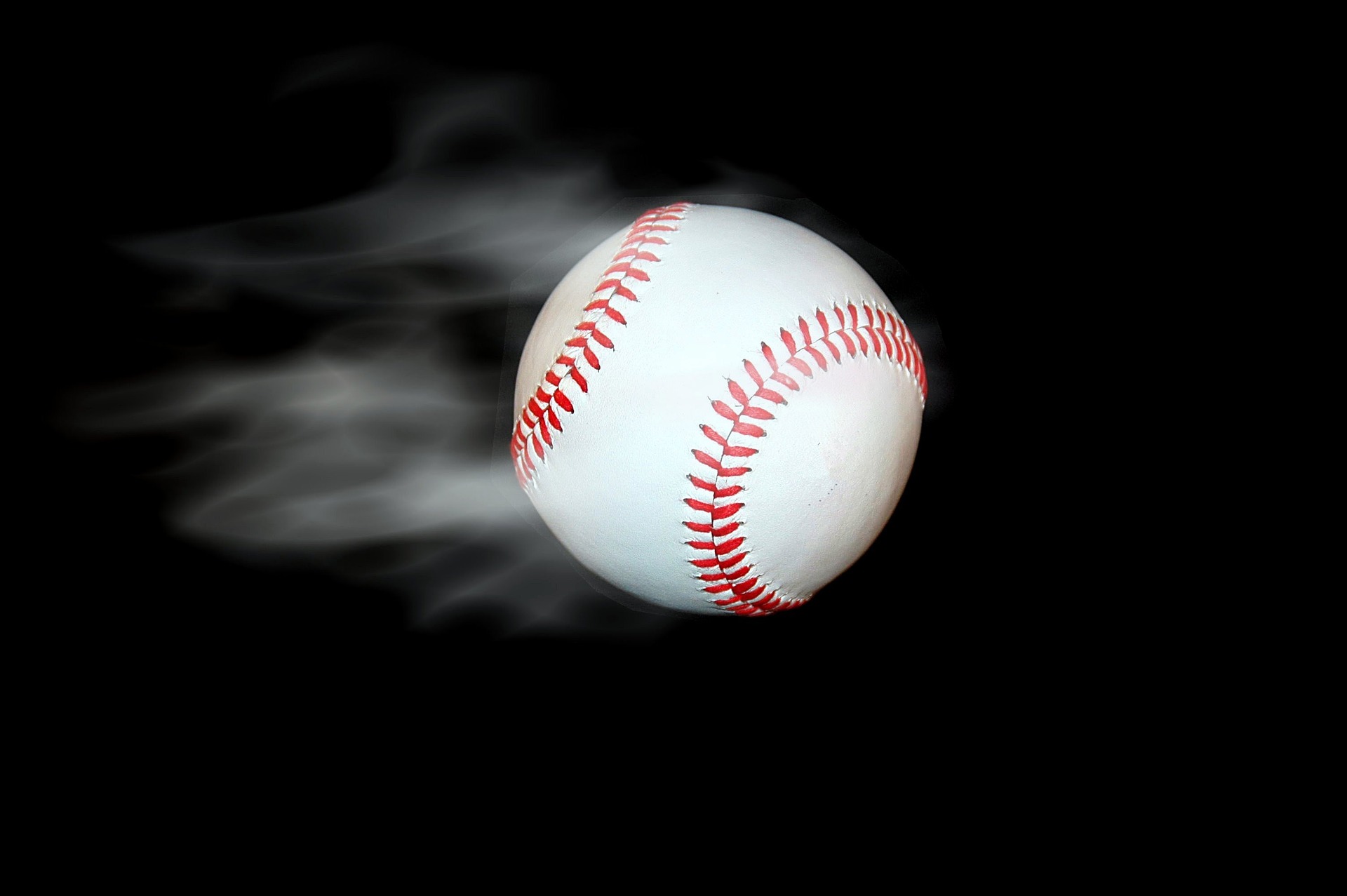 Picture of baseball with smoke trailing behind it representing a baseball fan grand slam.