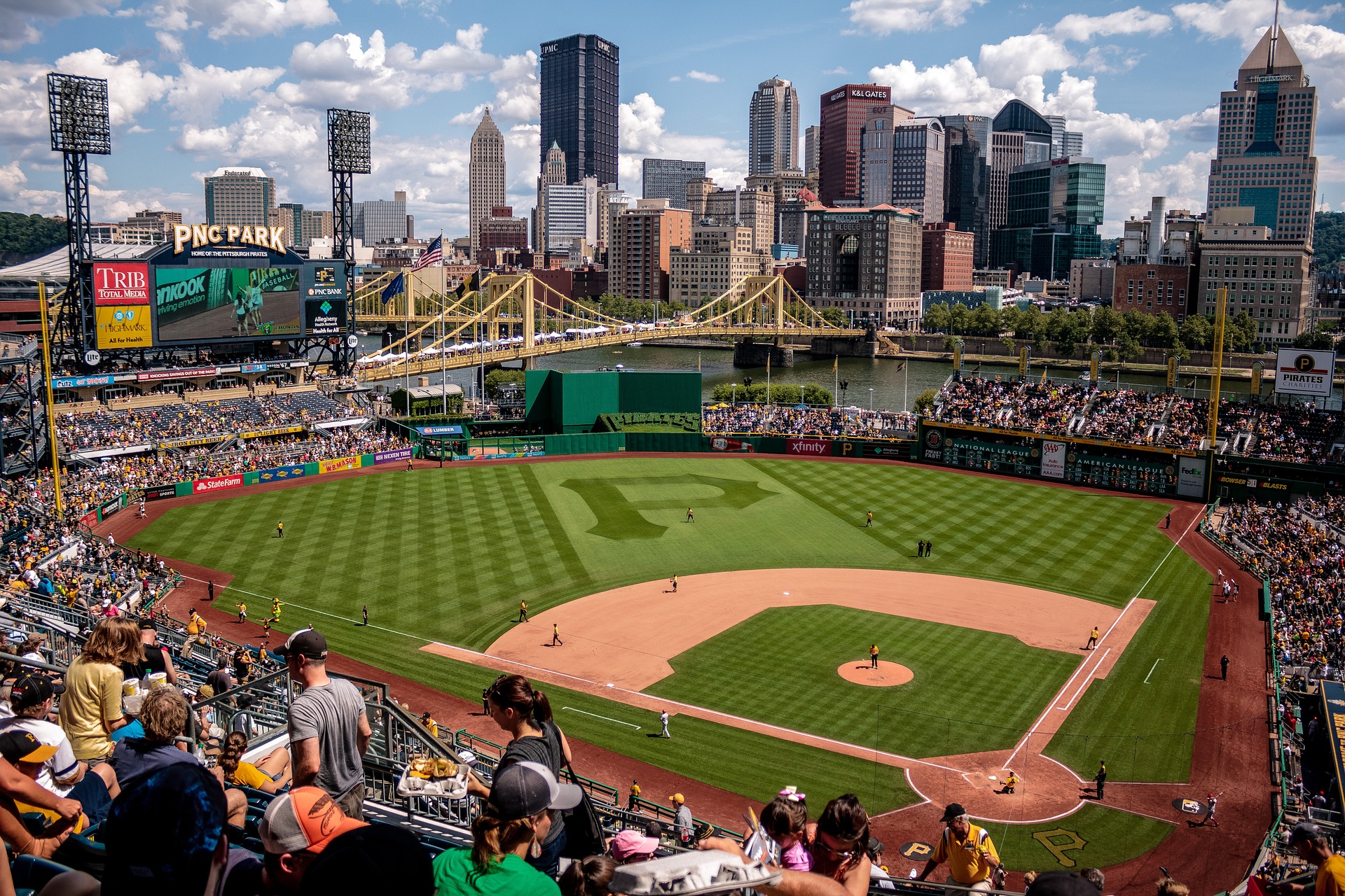 Image of Pittsburgh Pirates Stadium, filled with fans, with city skyline in the background. Image is meant to illustrate that employee homelessness is prevalent in big cities. Image by Pexels from Pixabay