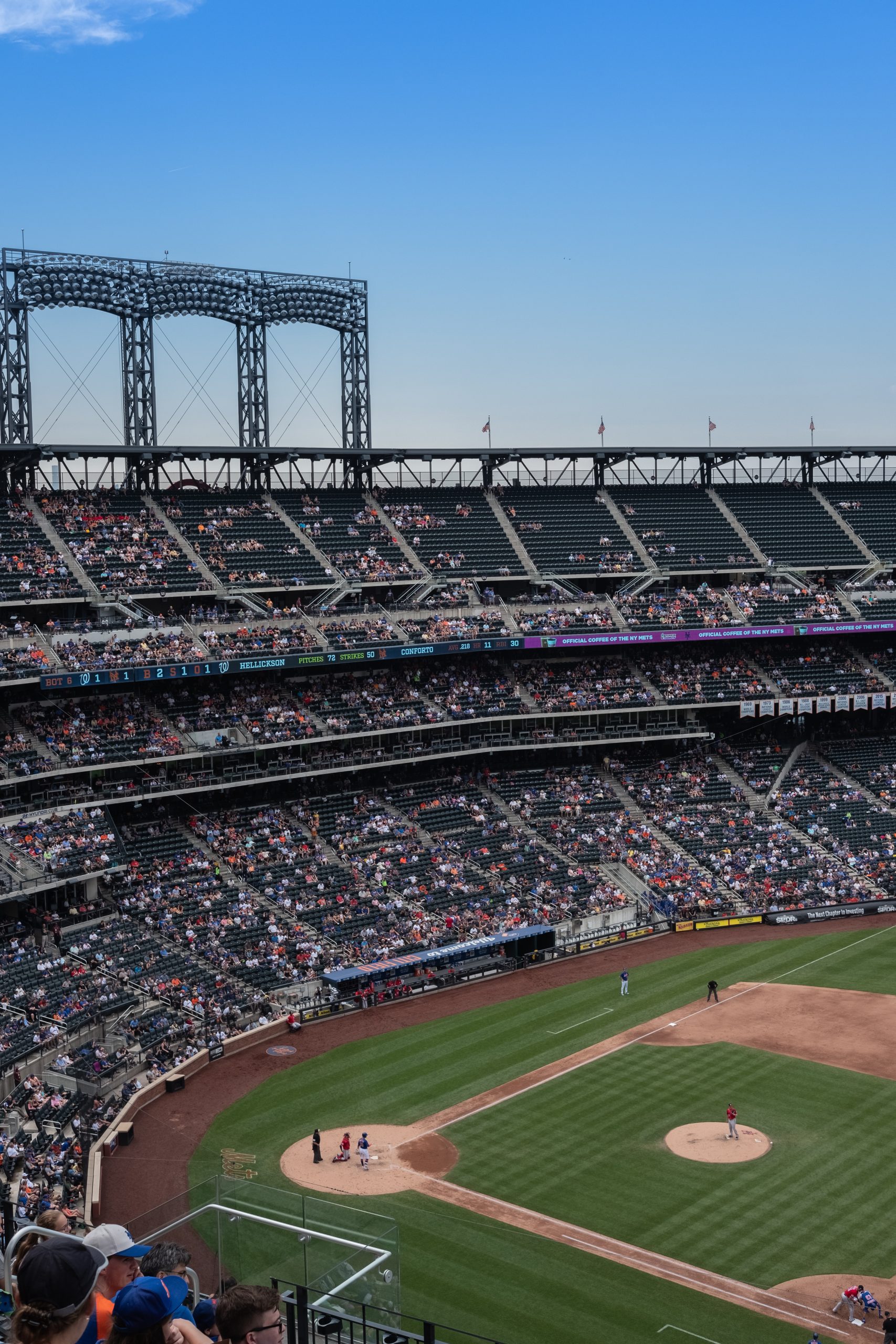 A photograph of fans in the Citi Field Stadium, with part of the baseball diamond in the foreground.