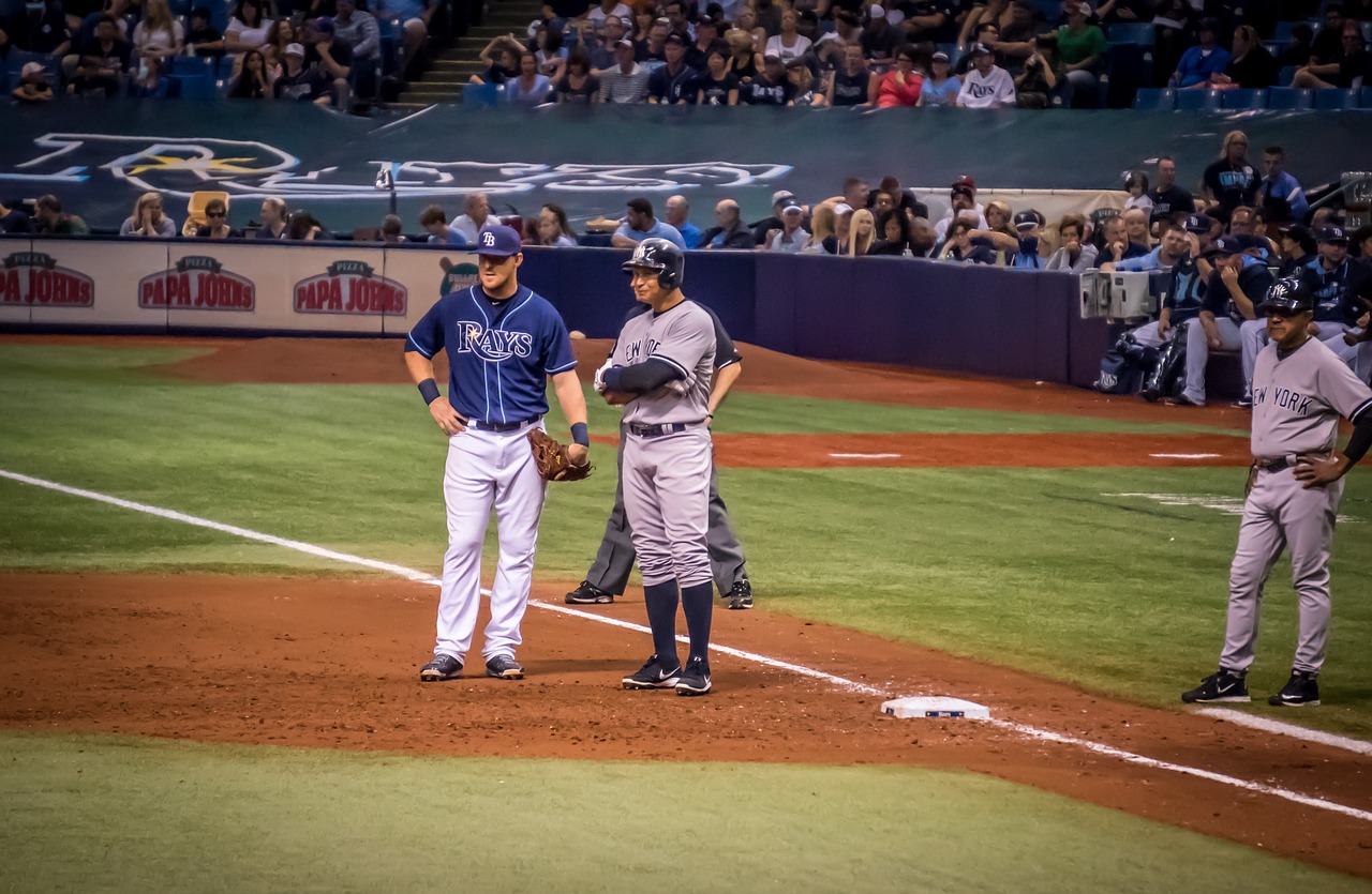 Picture of two players, one from NY and one from the Tampa Bay Rays, on the field at Tropicana Field.
