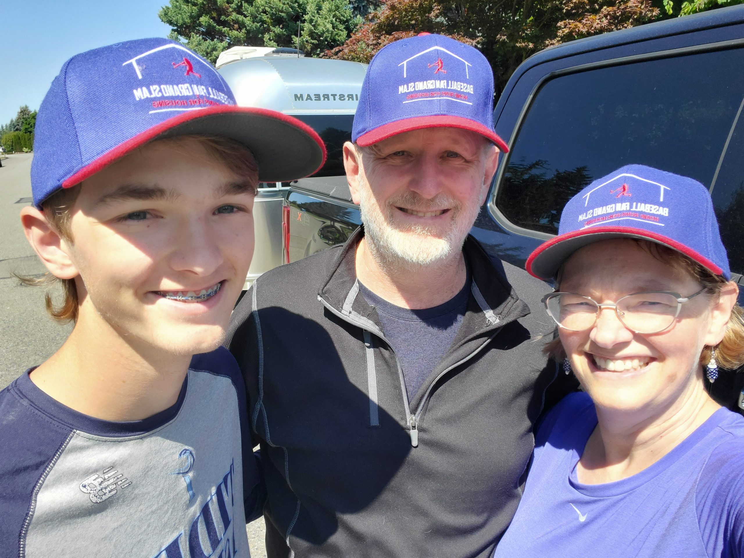 Photograph of Ryan, Brad, and Heather in Baseball Fan Grand Slam hats.