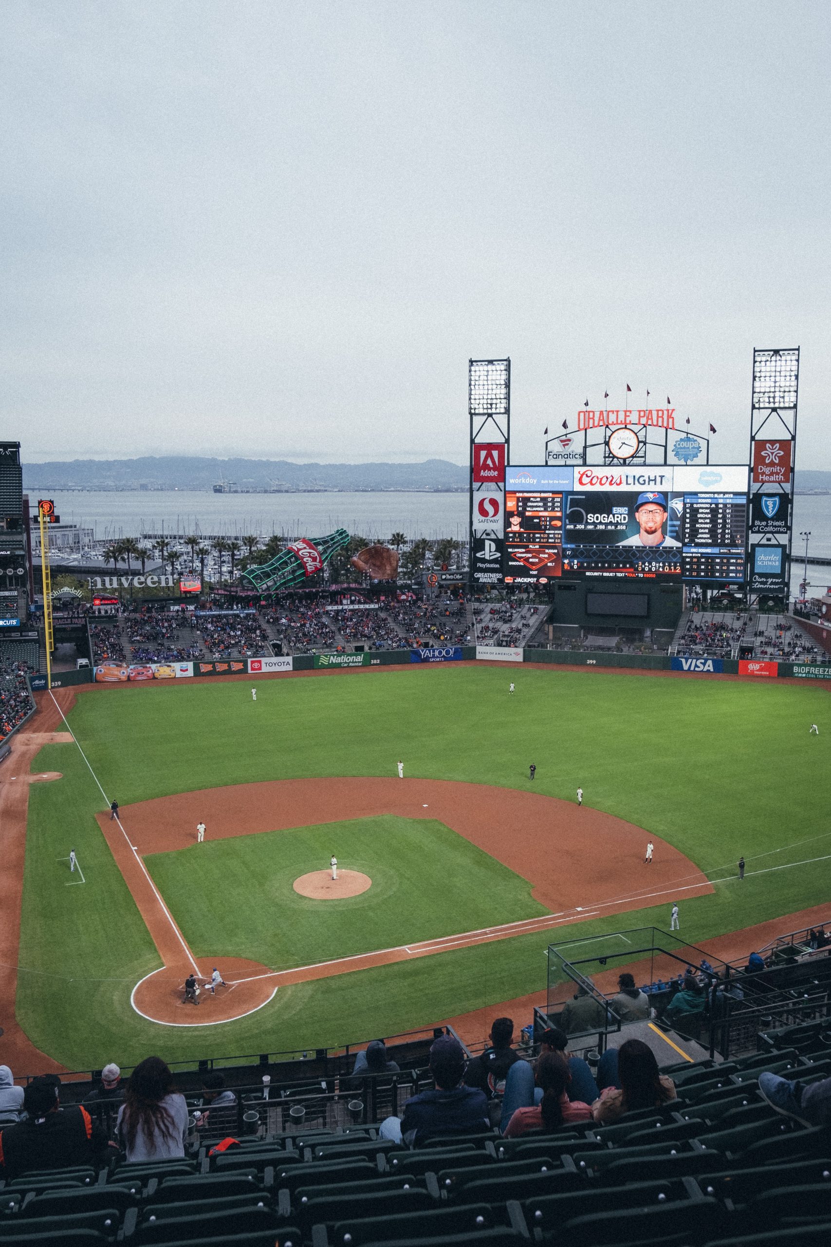 Picture of Oracle Park looking toward McCovey Cove, with a Giants baseball game underway