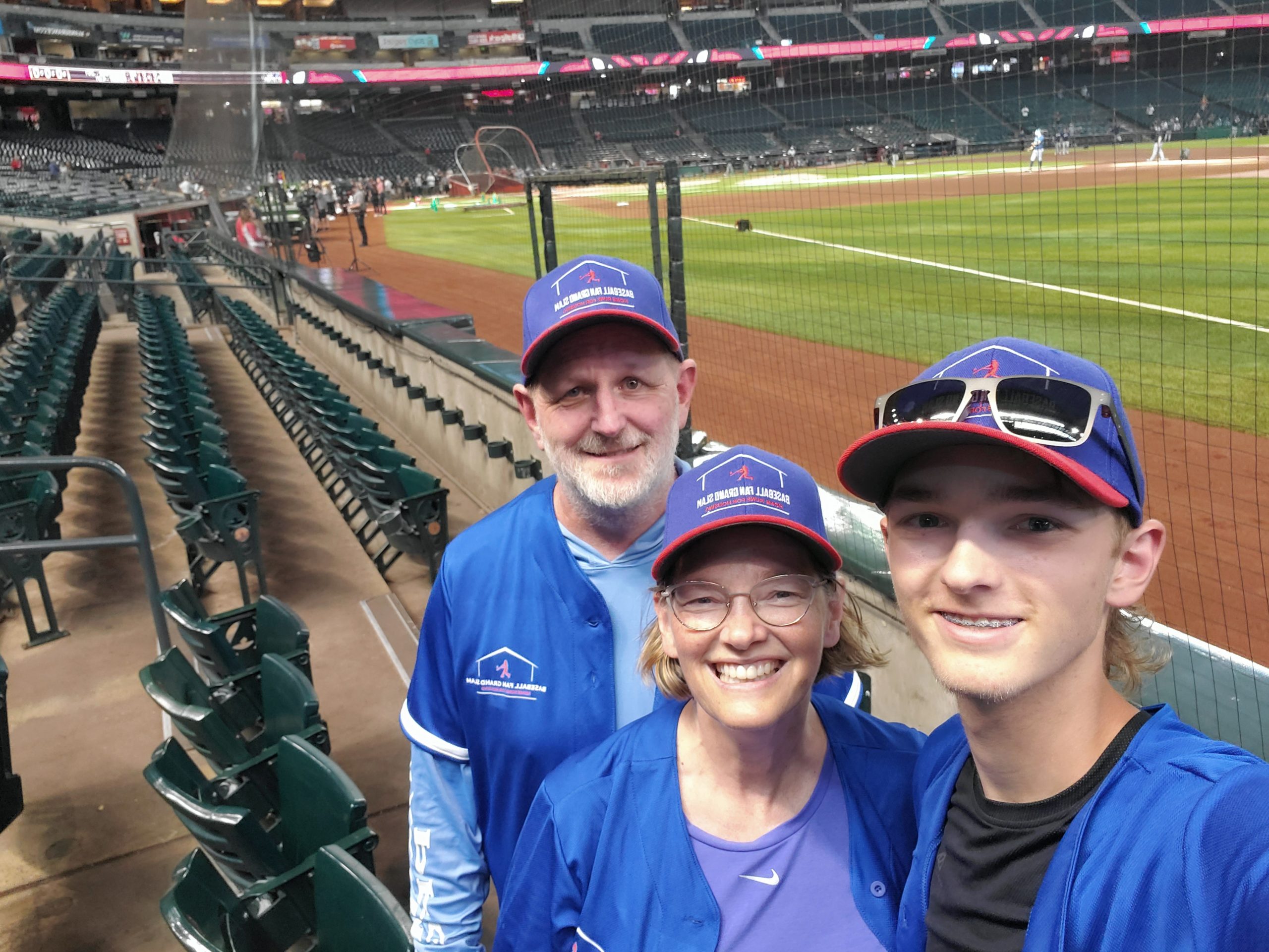 Photo of Ryan, Heather, and Brad in matching blue jerseys at Chase Field in Arizona.