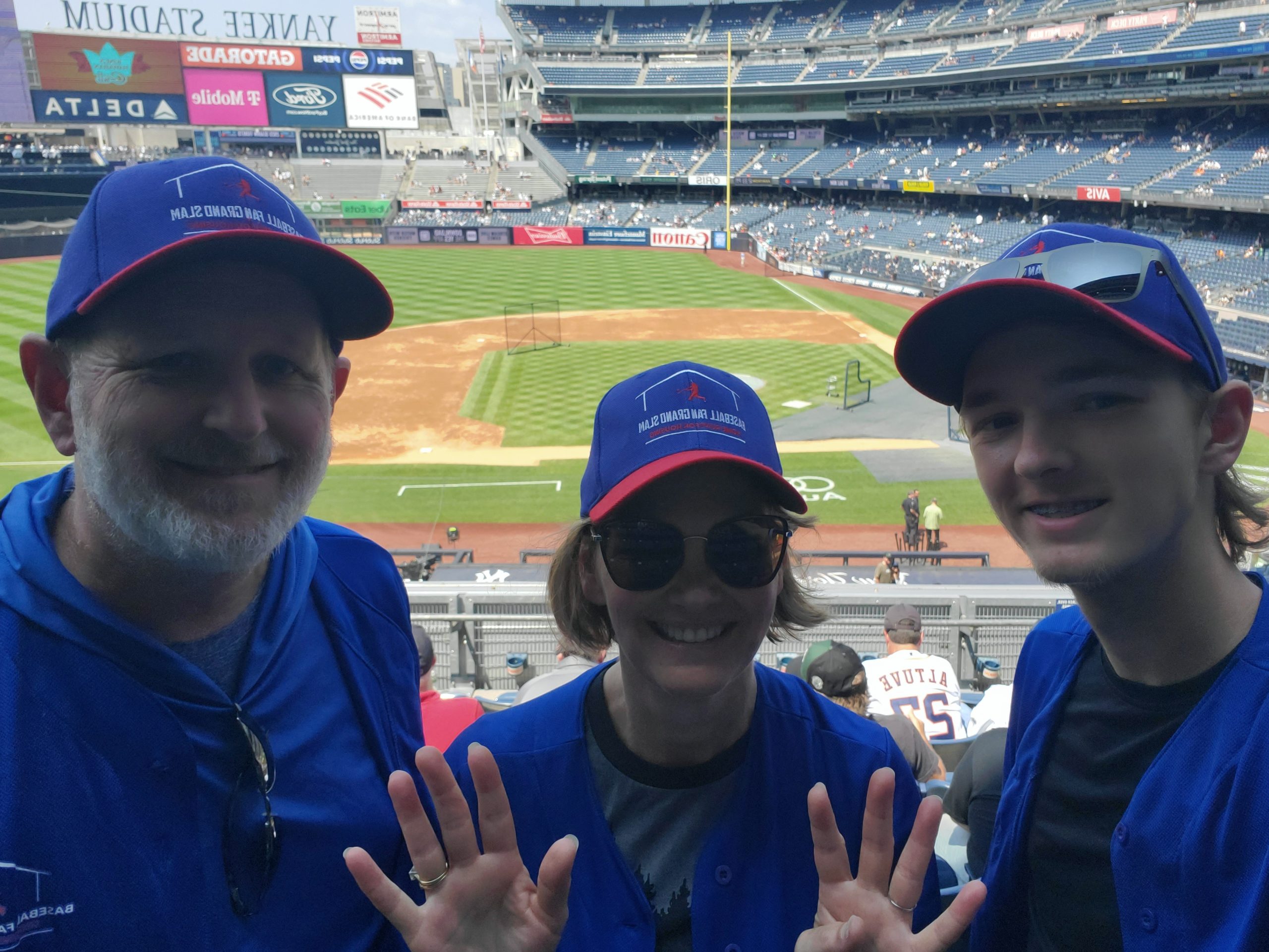 Brad, Heather & Ryan in front of the diamond at Yankee Stadium with 9 fingers up to represent the ninth stadium on the tour!