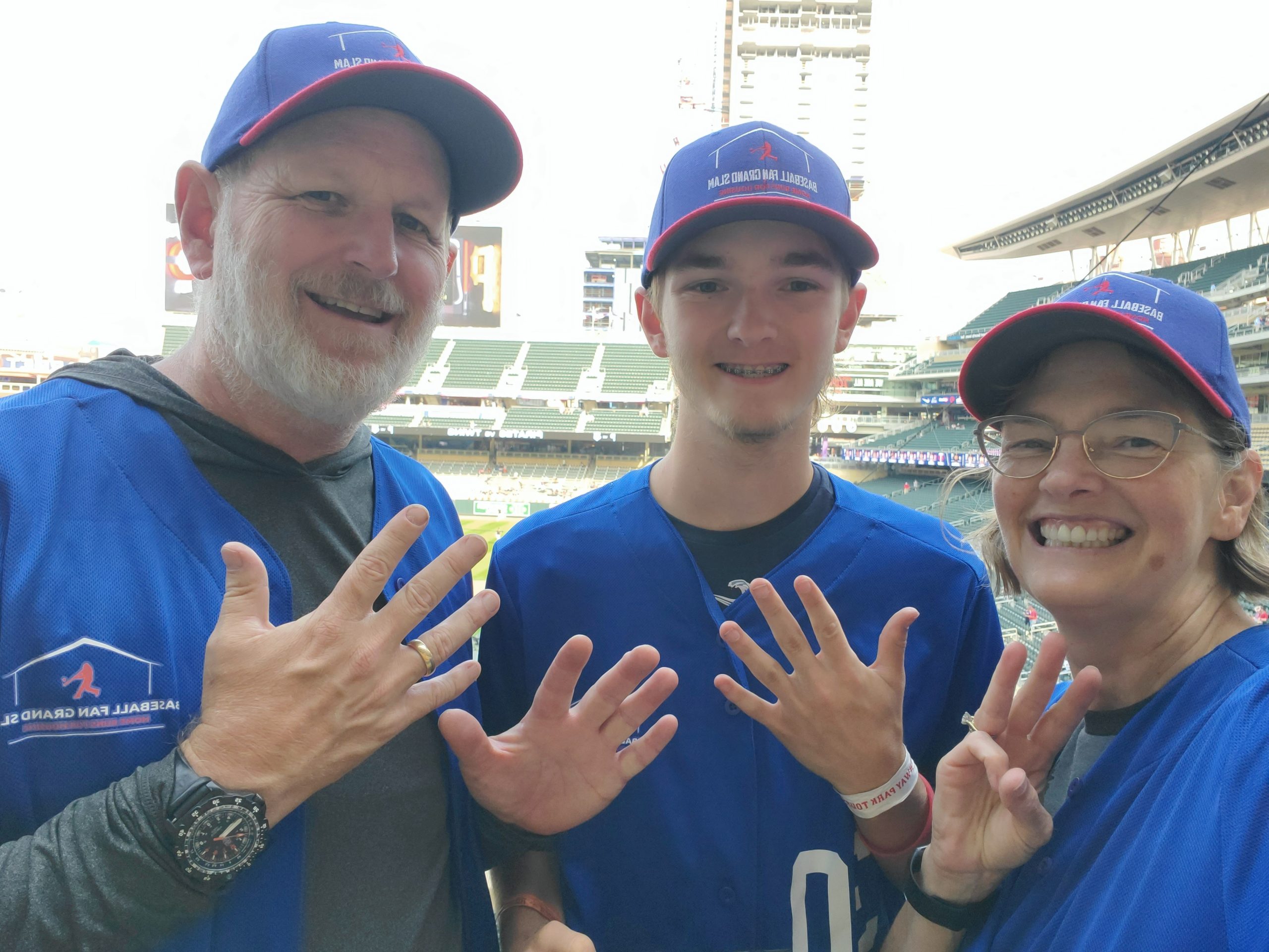 Brad, Heather, Ryan at Target Field holding up 18 fingers.