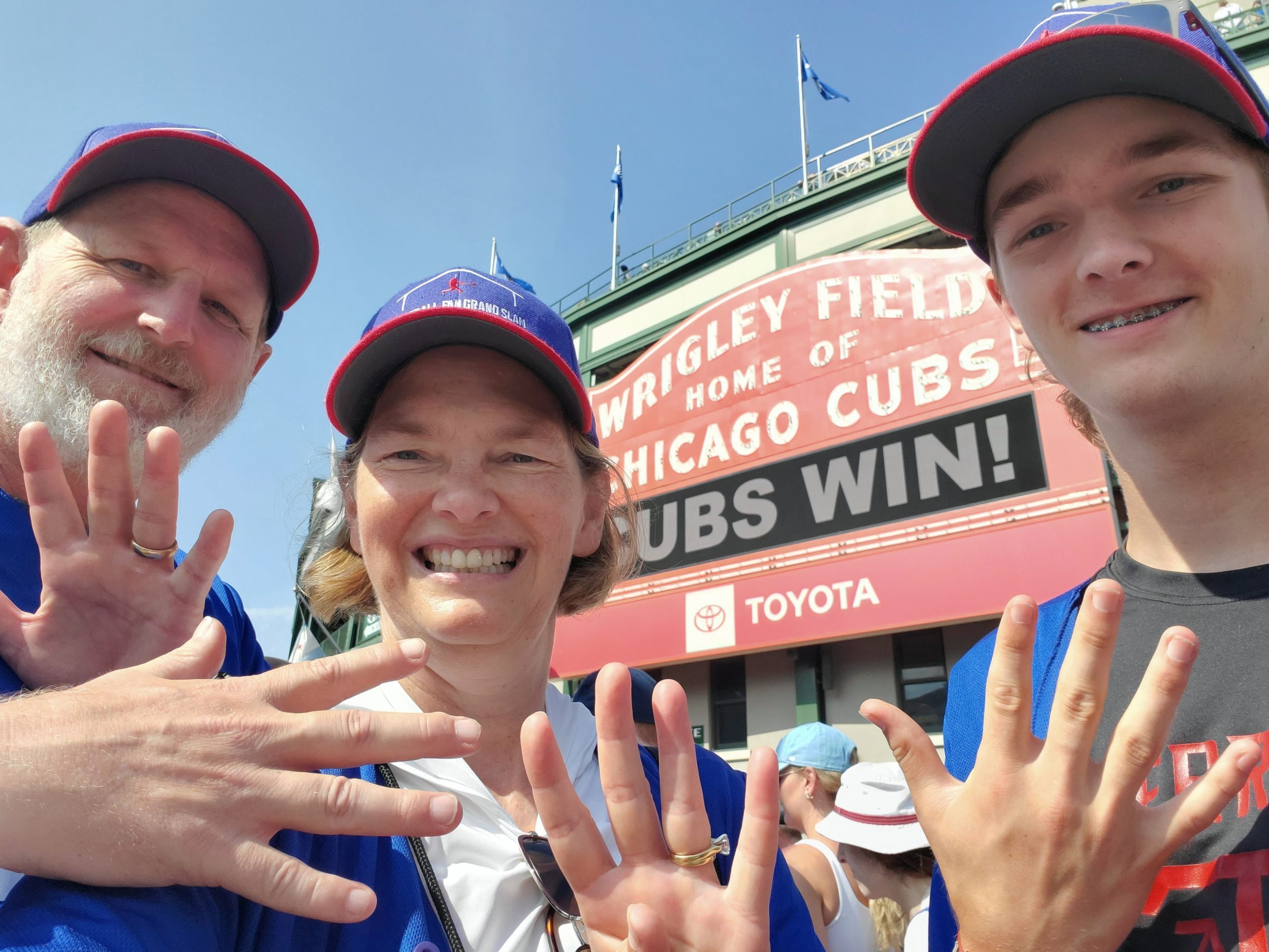 Heather, Brad and Ryan with 19 fingers up, representing the 19th stadium: Wrigley Field.
